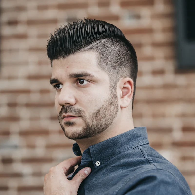 Topete penteado para trás com degradê nas laterais